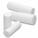 Four short white PTFE billets in different diameters leaning together on a white background