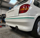 Green trim strip fitted along a white Fiesta RS Turbo's rear bumper