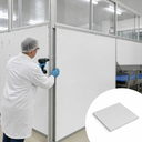 Fitter in a hairnet screwing white cladding panels to a partition in a food plant, inset white sheet