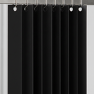 Close-up of black PVC strips hooked onto a stainless rail with round eyelets