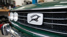 Silver leaping stag grille badge fitted to a green Triumph Stag Mk1 front grille