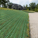 Green polymer mesh ground reinforcement with 11mm hexagonal openings for grass protection and slip-resistant flooring