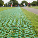 Green polymer mesh flooring with hexagonal openings for grass protection and slip-resistant ground reinforcement