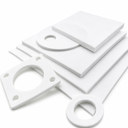 White PTFE sheets on white with cut flange gaskets and rings laid in front of them