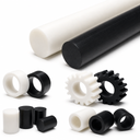 White and black acetal rod above machined gears, rings and short bar offcuts, studio shot on white