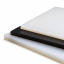 Three HDPE sheets stacked on white, translucent natural over black over milky-white, cut edges to front