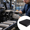Engineer fitting a black plastic wheel into a roll-forming machine above steel rollers, inset black block