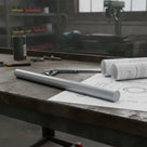 Grey PVC rod on a rusty bench over a technical drawing with callipers and rolled prints