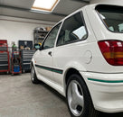 Black side mouldings with green and white stripe fitted to a white Fiesta's sill