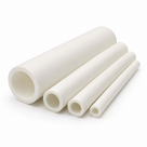 Four white PTFE tubes stepped from wide to narrow bore, sawn ends fanned towards the lens, plain white ground