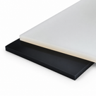 Milky-white translucent sheet resting on a black sheet, both edges square-cut, on white