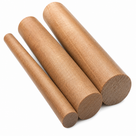 Three brown phenolic cotton rods stacked at an angle on white, sawn ends showing the fabric grain