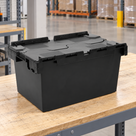 Illustrative warehouse use of 80L polypropylene hinged-lid crate with black base and black lids