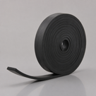 Black rubber strip wound into an upright coil with a wide centre hole, tail curving down to the front
