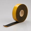 Roll of black sponge rubber strip on a card core, tail unrolled forward with the yellow liner underneath