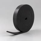 Upright coil of black rubber strip, layered edge on show and the loose end curling to the left