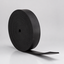 Thick black rubber strip coiled into a roll, standing upright with the tail sweeping out to one side