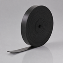 Tightly wound coil of narrow black rubber strip on a plain grey surface, free end curling out at the base