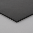 Black rubber sheet corner raised on a white surface, matte textured face with a square edge showing thickness