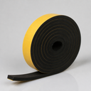 Coil of thick cellular sponge rubber strip, yellow backing paper on one face, square-cut tail at the front