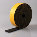 Deep roll of black sponge rubber strip on edge, broad yellow adhesive face and a chunky flat tail