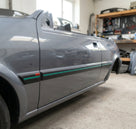 Black side mouldings with green insert fitted along a grey Fiesta RS Turbo's doors