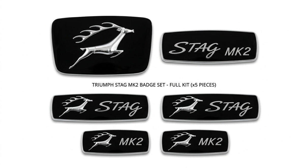 Flat lay of five black and silver Triumph Stag Mk2 badges including STAG MK2 scripts