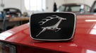 Black and chrome bonnet badge with leaping stag emblem fitted to a red Triumph Stag Mk2