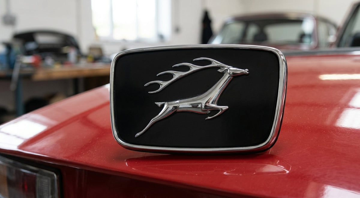 Black and chrome bonnet badge with leaping stag emblem fitted to a red Triumph Stag Mk2