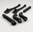 Six black wiring grommets of various shapes laid out, studio shot