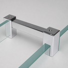 Square chrome bar in the studio, a U-clamp at each end gripping two separate green-edged glass panels.