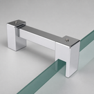 Square chrome bar in the studio with one U-clamp gripping a green-edged glass panel and the other left open.