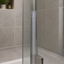 Clear T-shaped seal running down the vertical edge of a wet glass shower screen