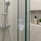 Clear teardrop-loop seal down a glass panel edge, chrome riser rail and handset visible through the glass
