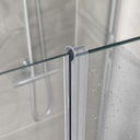 Clear hook-profile seal fitted at a glass shower door hinge post, tiled wall behind.