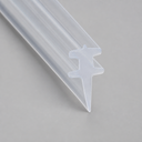 Clear T-top seal with swept double wings tapering to a pointed spike, studio shot on grey.
