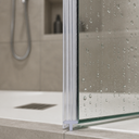 Clear T-seal highlighted in blue, fitted to the hinge edge of a wet bifold shower door.