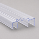 Two clear U-channel seals with wavy top edge shown diagonally on a plain grey studio background.