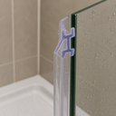 Clear seal highlighted in lilac, fitted at a glass corner joint above a bathtub.