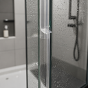White T-seal fitted at the top edge of a glass shower panel, niche shelf behind.