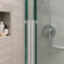 Lilac-tinted twin-slot bracket seal fitted where two glass panels meet on a chrome frame.