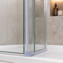 Translucent hooked seal fitted where two shower panels meet, mixer tap visible behind.