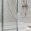 Clear seal fitted vertically along a shower door edge, shower head and hose visible.