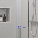 Clear seal fitted along a glass shower frame edge, warm-toned tiles visible behind.