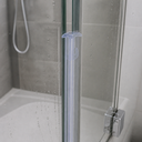 Clear seal fitted vertically in a shower alcove, shower head and white bath visible.