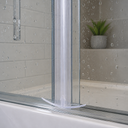 Clear arrow-hook seal fitted at the base of a glass shower door, plant on the shelf behind.