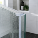 Lilac plain T-seal fitted at a glass shower corner, bottle and plant on shelf behind.