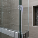 White hook seal fitted at a glass shower door edge, chrome mixer tap behind.