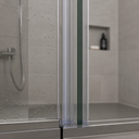 Clear seal fitted between two tinted glass edges, bathroom niche shelf with bottle behind.