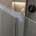 Blue-outlined stepped seal fitted at a glass panel top corner, bottle and heater behind.